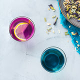 Butterfly Pea Flower tea changing color with citrus fruit added. 